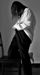 Model in black pants and white shirt. Black and white