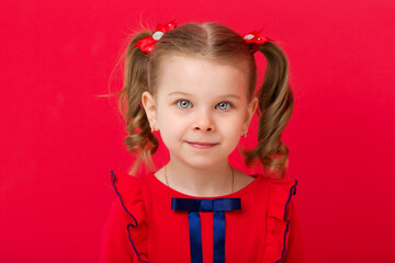 Cute blue eyed girl staring at camera in studio