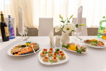 Beautiful table served with glassware and cultery, prepared for festive event.