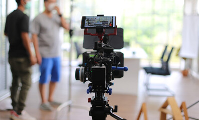 Fototapeta na wymiar Selected focus on camcorder film broadcast against blurred background.