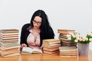 female teacher at a table with books for teaching