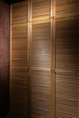 blinds wooden wardrobe door with clothes