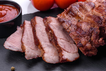 grilled beef steaks with spices on a dark cutting board