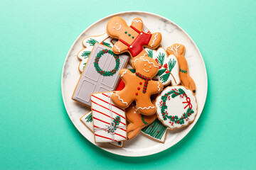 Christmas composition with decorations and cookies on a mint background