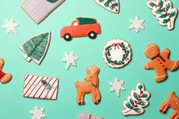 Christmas composition with decorations and cookies on a mint background