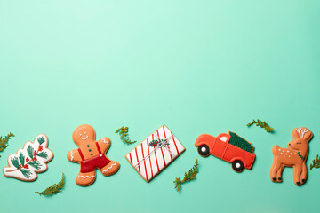 Christmas composition with decorations and cookies on a mint background