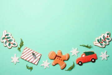 Christmas composition with decorations and cookies on a mint background