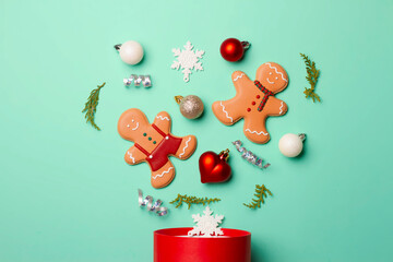 Christmas composition with decorations and cookies on a mint background