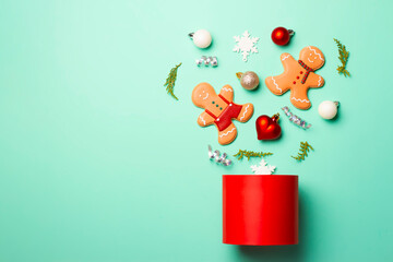 Christmas composition with decorations and cookies on a mint background