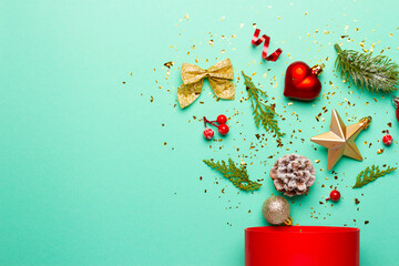 Christmas composition with decorations and ornaments on a mint background