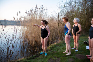 Women looking at water while standing at waterfront