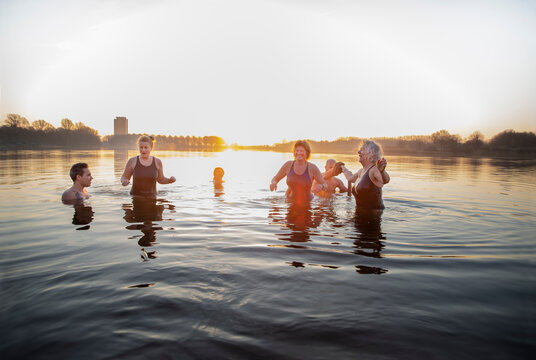 Cheerful male and female friends enjoying cold water