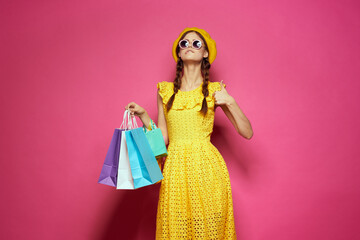 cheerful woman yellow dress shopping fun isolated background