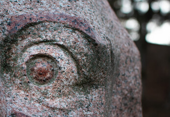 Eye of granite monument close up moss covered
