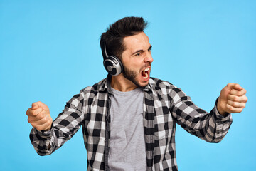 Fototapeta premium emotional bearded man listening to music with headphones technology