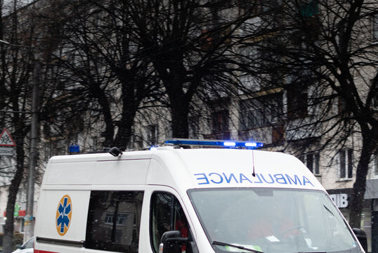 Ambulance Car With Flashing Lights On The Roof On City Street At Daytime