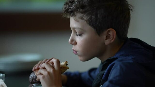 Child eating morning breakfast. Kid eats bread
