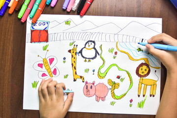 Children use marker coloured pens to sketch imagined animals on white paper