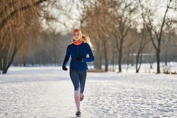 Woman jogging during winter