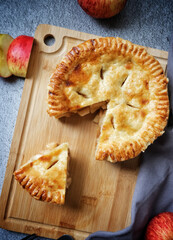 Apple pie on wood board with fresh apple