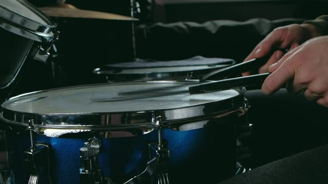 close up - the drummer plays with brush on a snare drum, home lesson paradiddle training