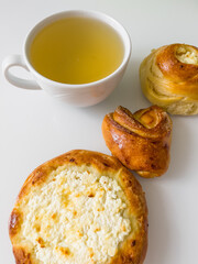Morning tea with delicious buns. Cup of hot tea with delicious buns for tea drinking