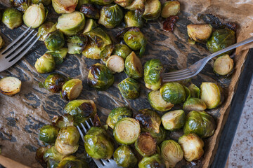 oven baked sliced brussels sprouts on baking tray closeup
