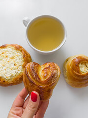Morning tea with delicious buns. Cup of hot tea with delicious buns for tea drinking
