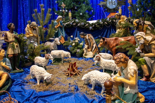 Nativity scene with the image of the Holy Child, the Most Holy Theotokos, St. Joseph, the Magi, a sheep, a bull and a donkey. Christmas.