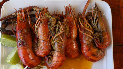 Fried shrimps on white plate closeup top view