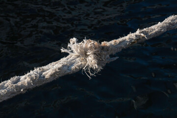 stretched and frayed rope detail, worn rope