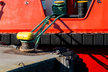 The tugboat waiting tied to the pier...The rubber fenders of the boat