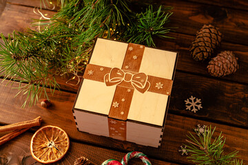 wooden box with an engraving of a bow and ribbon on the lid