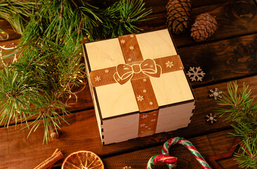 wooden box with an engraving of a bow and ribbon on the lid