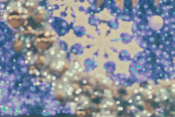 Blurred bokeh of Christmas light and decorative ball background.