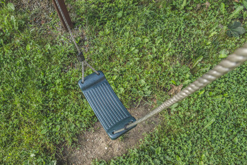Empty swing on children playground in a public park.