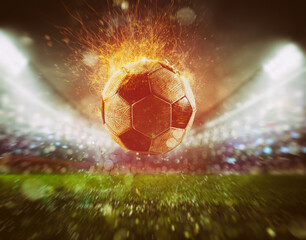 Close up of a fiery soccer ball kicked with power at the stadium scoring a goal