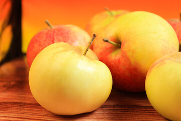 red and yellow apples on an orange background. fruits, healthy lifestyle, healthy food