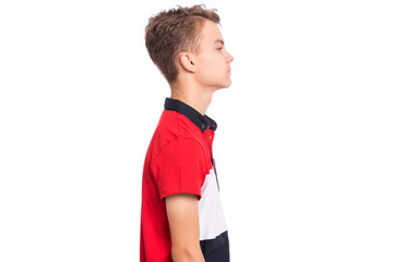 Profile portrait of serious young boy, isolated over white background. Teen boy looking away.