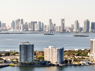 downtown miami in the background of island with buildings aerial view