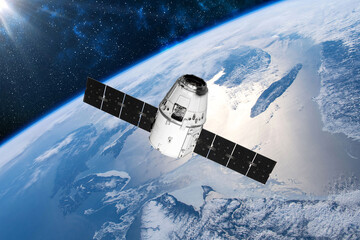 Fototapeta premium Cargo space craft and Earth planet. Dark background. Sci-fi wallpaper.Space Station Orbiting Earth.Space ship. Space art wallpaper.Solar Observatory.Elements of this image furnished by NASA.