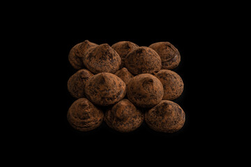 Chocolate truffles on a black background.