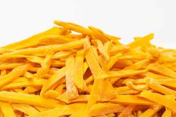 Dry tasty mango slices as a background.