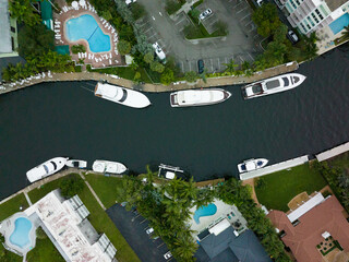 eagle eye view of river with many boats and yachts docked in florida