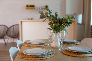 Breakfast setup on wooden table with nice vase and modern chair.