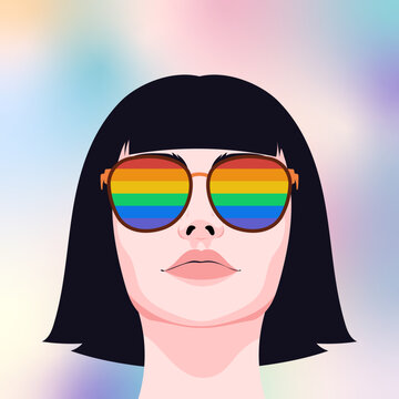Person wearing rainbow pride sunglasses
