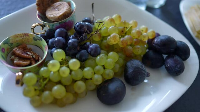 Grapes, nuts, and figues assortment on plate