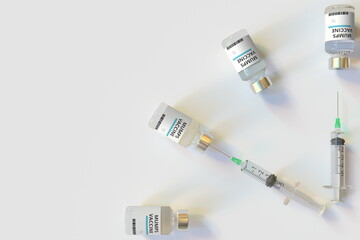 Clock face made with mumps vaccine vials and syringes. Vaccination time concept. Conceptual medical 3D rendering