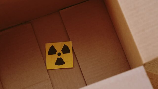 A radiation warning sign in a cardboard box. Close up.
