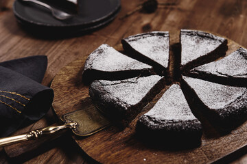 Kladdkaka. Traditional Swedish moist chocolate cake on wooden table. Fika. Hygge. Winter treat